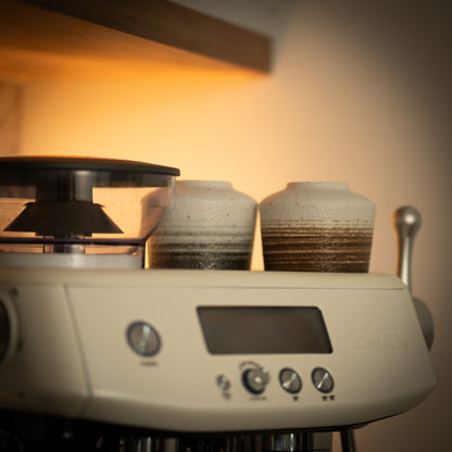 Ceramic Coffee Mugs Sitting On Breville Machine 